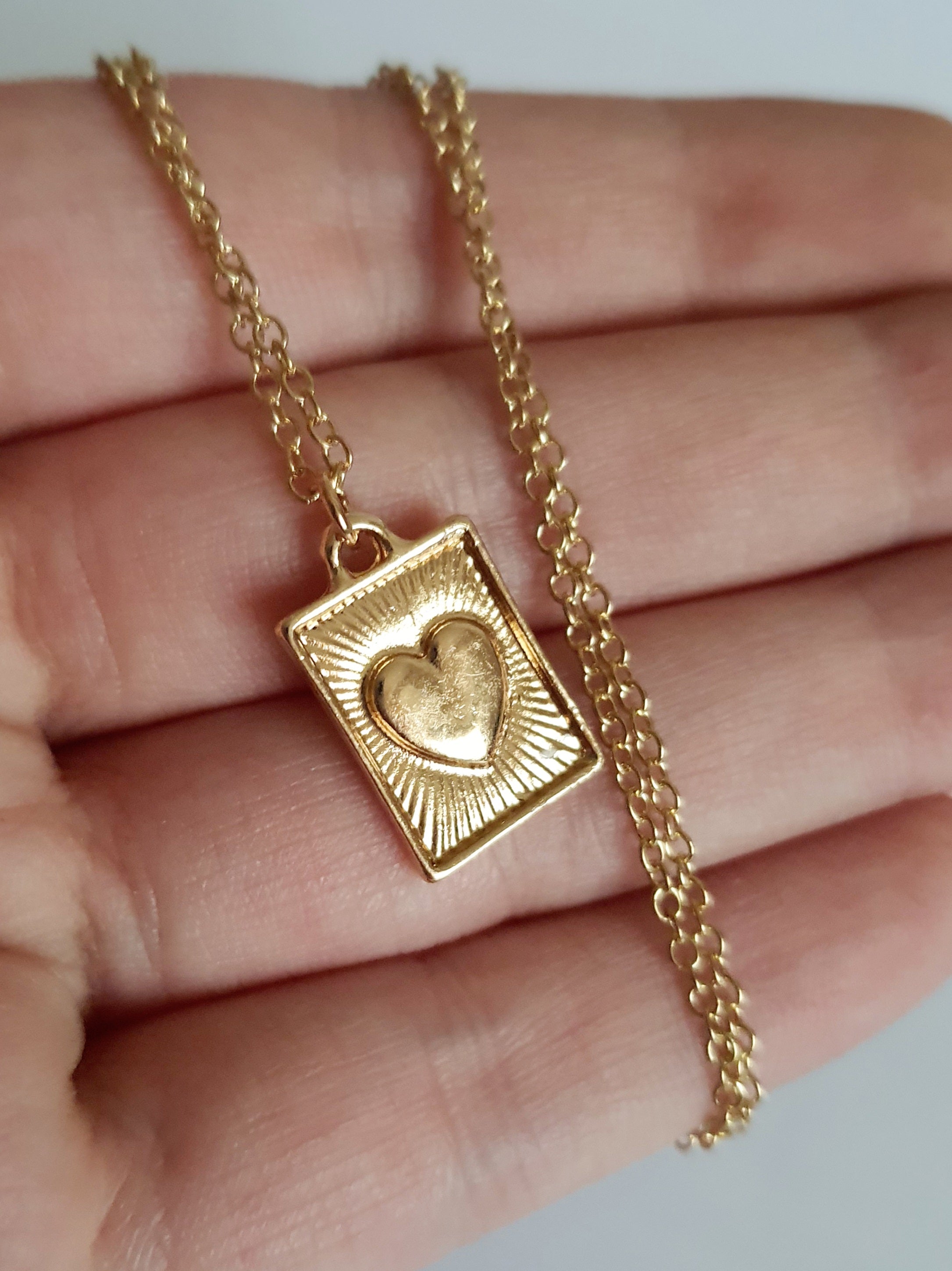 Złocony łańcuszek ze stali chirurgicznej, regulowana długość 38–46,5 cm, prostokątna zawieszka z sercem i promienistym wzorem, RougeBizu.