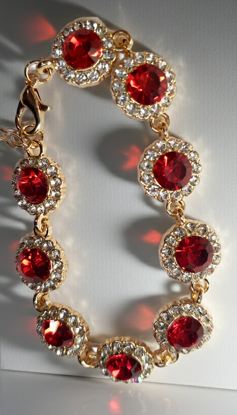 Bransoletka z czerwonymi kamieniami w złotej oprawie, długość regulowana 15–20 cm, styl glamour i elegancki. Stal nierdzewna, stal chirurgiczna, wodoodporne, hipoalergiczne, jakość premium, Rouge Bizu.