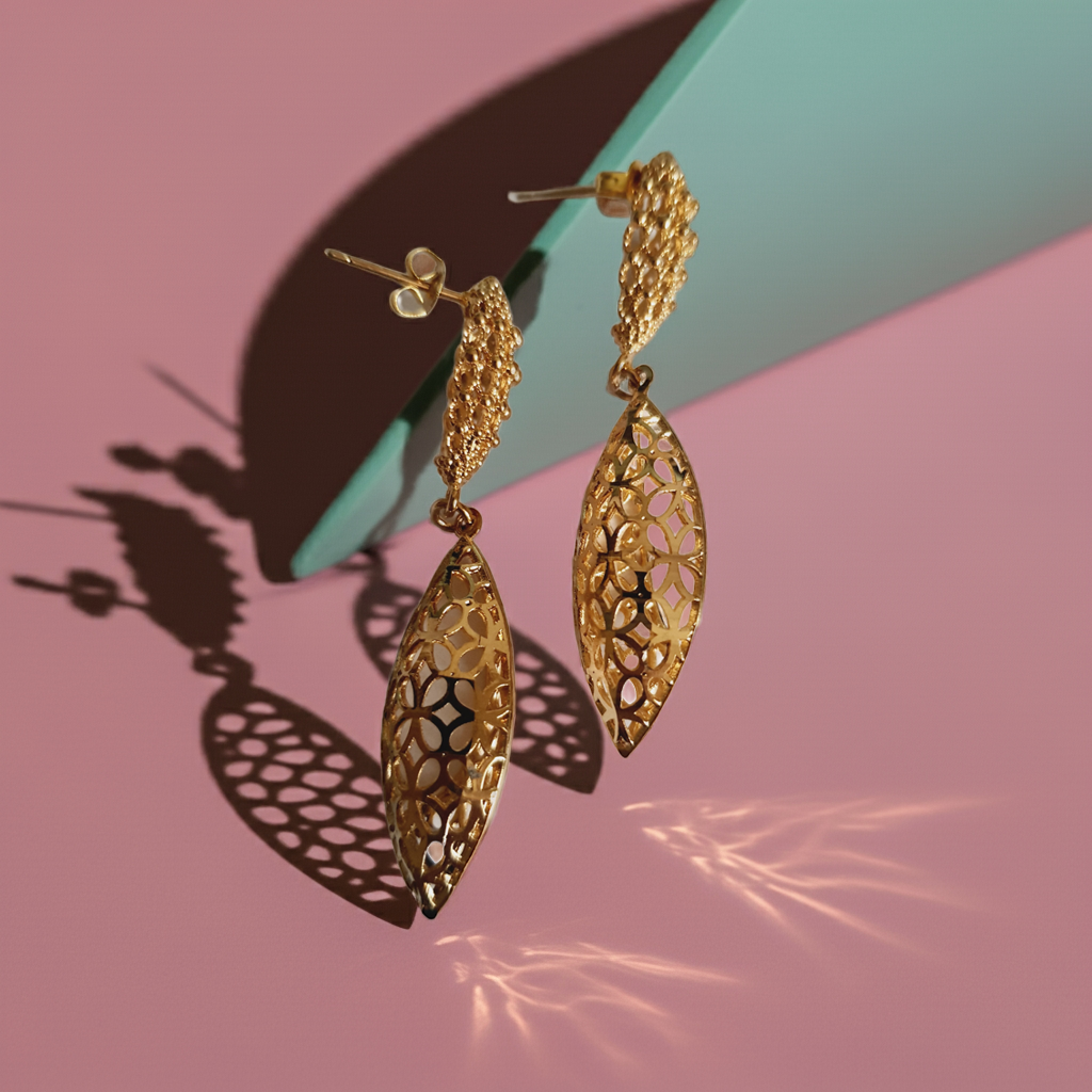 Złote kolczyki ze stali nierdzewnej w kształcie ażurowych liści. Eleganckie, lekkie i subtelne, idealne na co dzień i na wieczór. Długość 5,5 cm. Rouge Bizu.