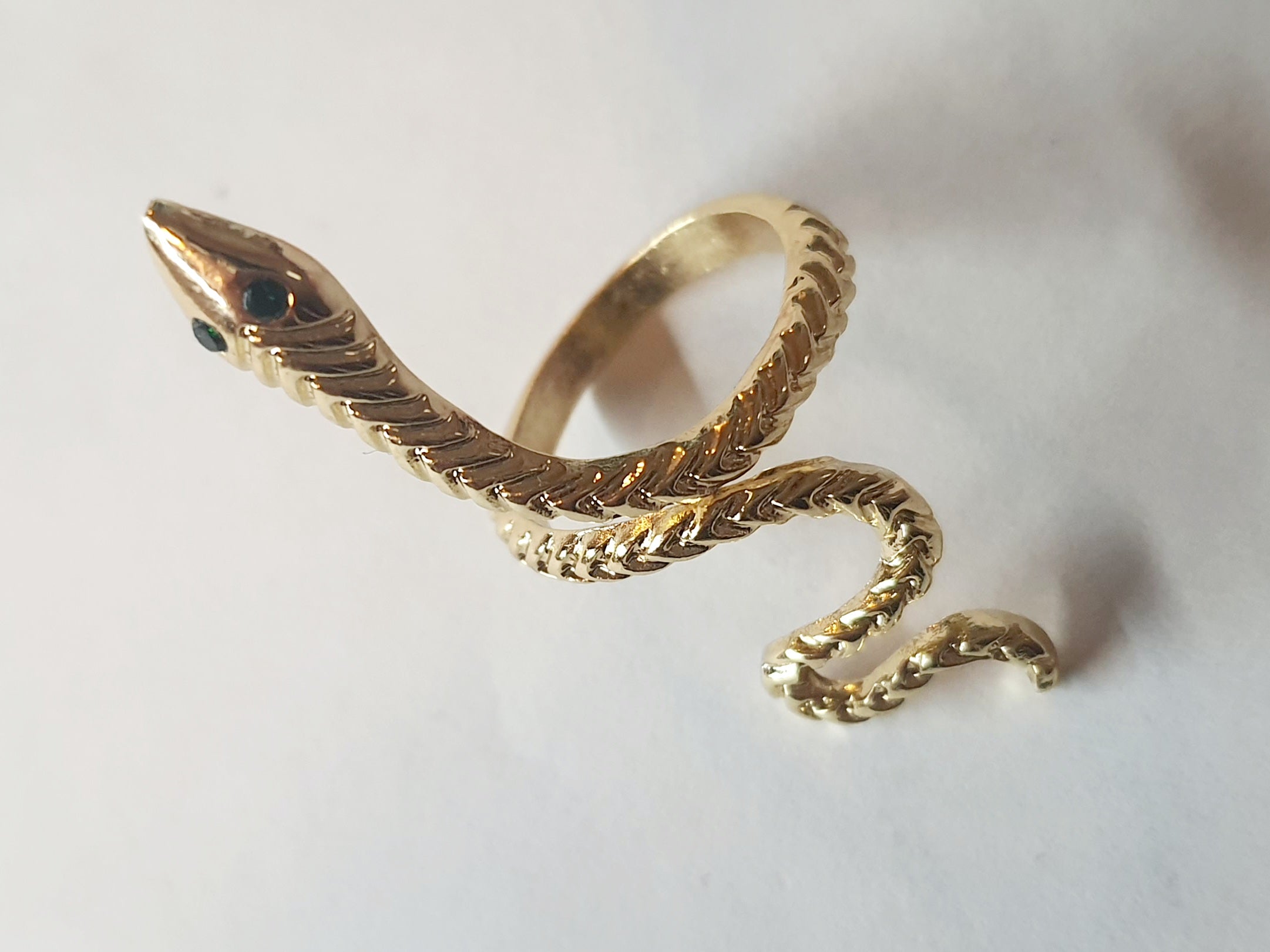 „Złoty pierścionek w kształcie węża z zielonymi oczkami, rozmiar 15 mm, wykonany ze stali nierdzewnej. Statement jewelry, modny i odważny design – Rouge Bizu.”