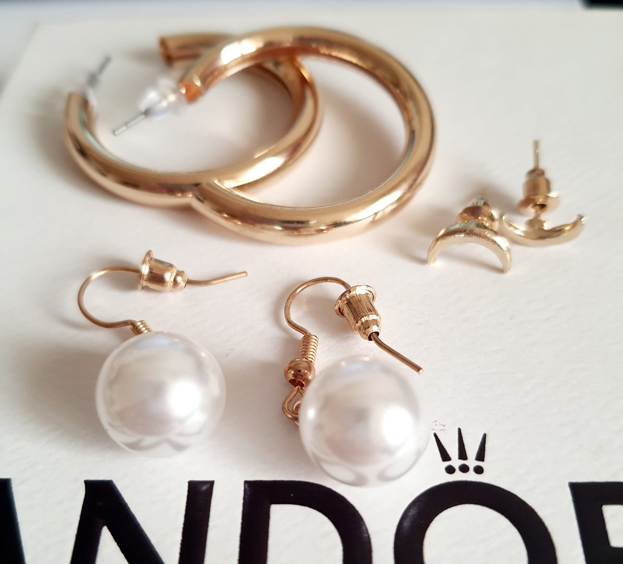 Stylowy zestaw trzech par kolczyków, który pozwala tworzyć różnorodne stylizacje – od minimalistycznej elegancji po delikatny romantyzm. stal nierdzewna. klasyczne kółka, wiszące perełki i wkręty z księzycem. rouge bizu