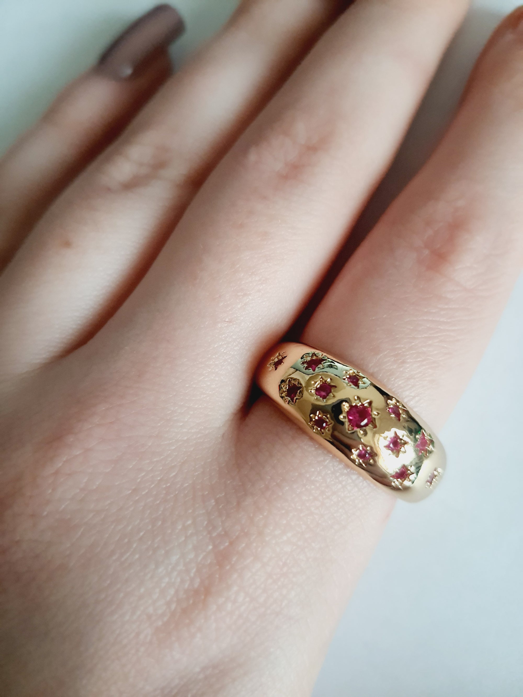 Złoty pierścionek ze stali nierdzewnej, ozdobiony czerwonymi kryształami w kształcie gwiazd. Elegancki, oryginalny, w stylu glamour. Rozmiar 20 mm. Rouge Bizu.