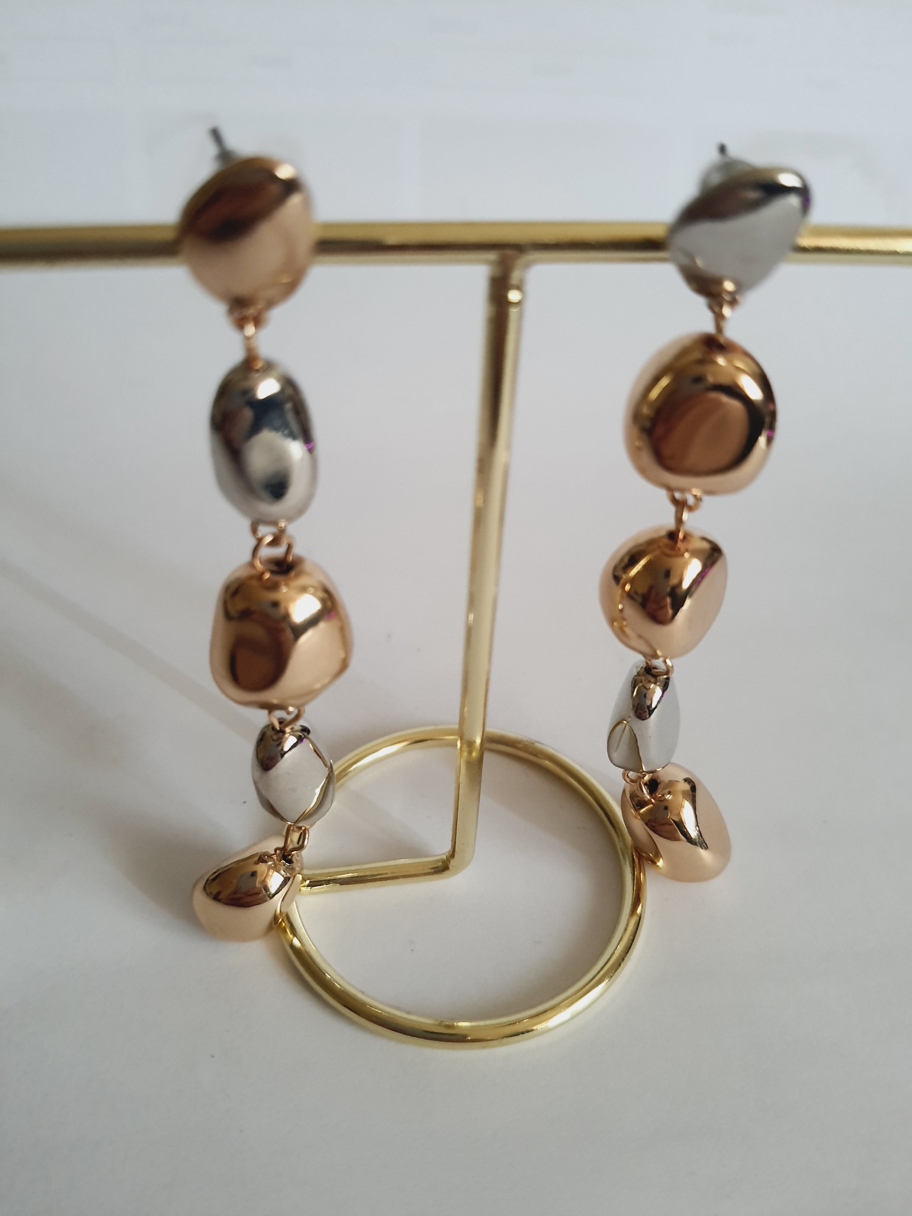 Długie kolczyki 9 cm ze stali nierdzewnej, w kolorze złotym i srebrnym, złożone z nieregularnych lśniących elementów, eleganckie i nowoczesne, Rouge Bizu.