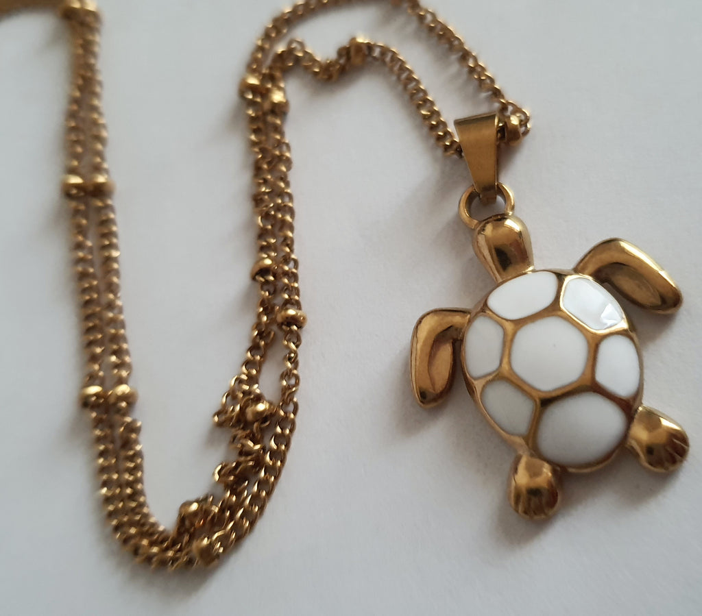 Naszyjnik złoty 40–45 cm ze stali nierdzewnej, zawieszka żółw z białą emalią na pancerzu, symboliczna i elegancka biżuteria, Rouge Bizu.#bizuteria #biżuteriapozłacana #stalnierdzewna #stalchirurgiczna #platerowane18k #wodoodporne #hipoalergiczne #retro #vintage #złotynaszyjnik #rougebizu