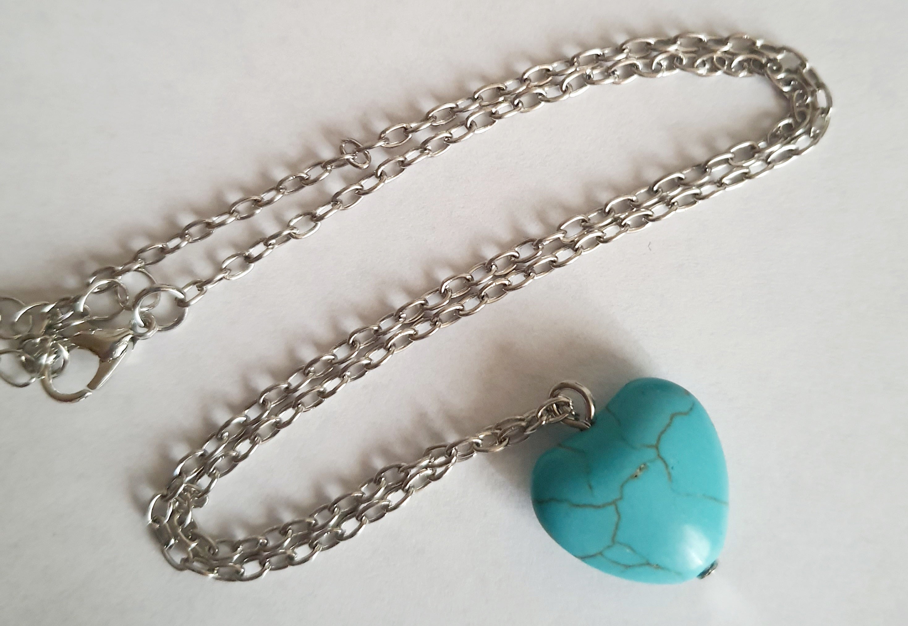 Srebrny naszyjnik ze stali chirurgicznej z zawieszką w kształcie turkusowego serduszka. Regulowana długość 41–48 cm. Stal chirurgiczna, stal nierdzewna, wodoodporne, hipoalergiczne, jakość premium. RougeBizu.