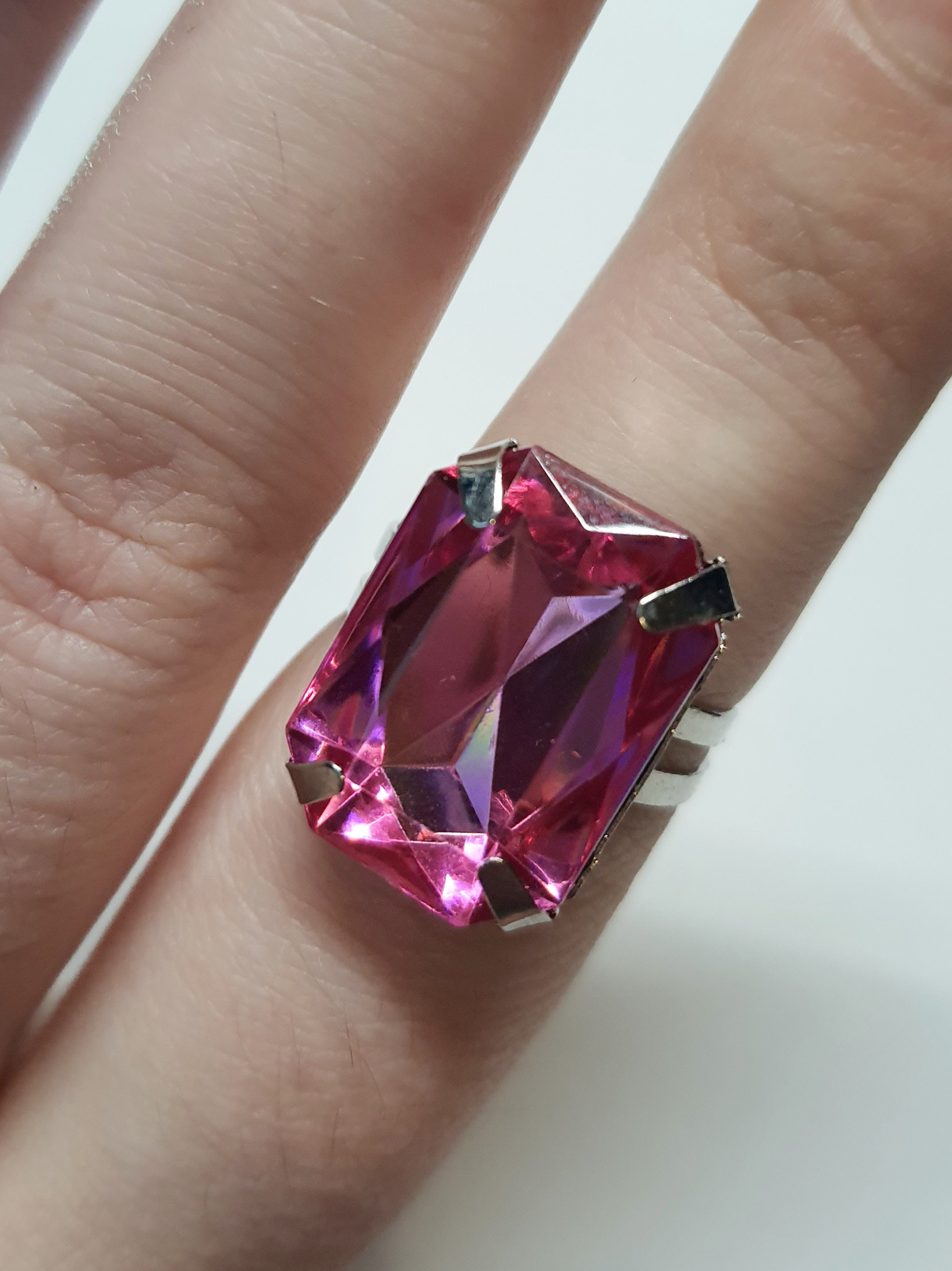 Srebrny pierścionek z dużym czerwonym kamieniem w prostokątnym szlifie, metal, elegancki styl, intensywny kolor, regulowany rozmiar, Rouge Bizu.