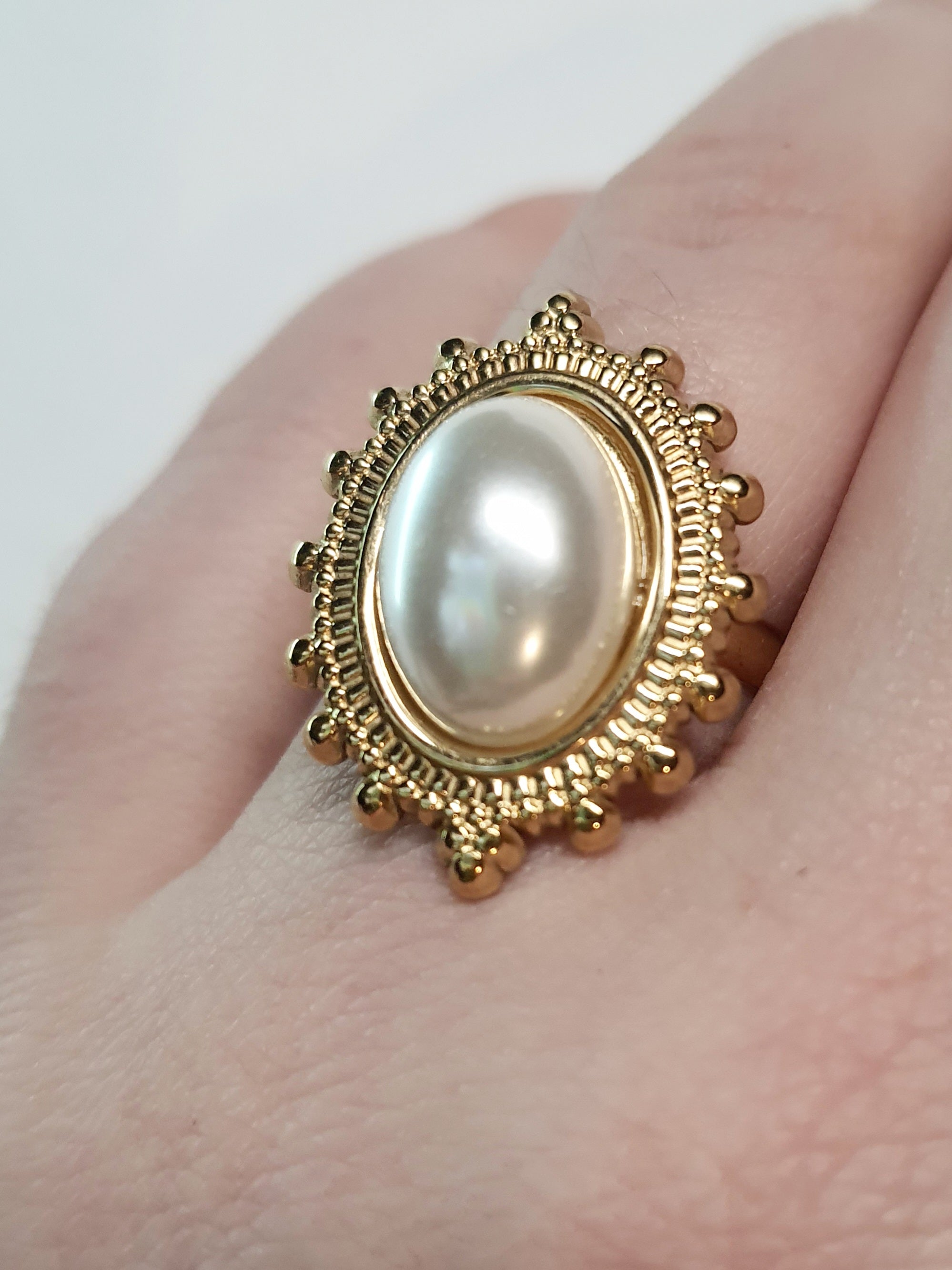 Złoty pierścionek z owalną perłą w stylu vintage, elegancki i klasyczny. Rozmiar 17 mm, lekko regulowany. Stal nierdzewna, stal chirurgiczna, wodoodporne, hipoalergiczne, jakość premium. Rouge Bizu.