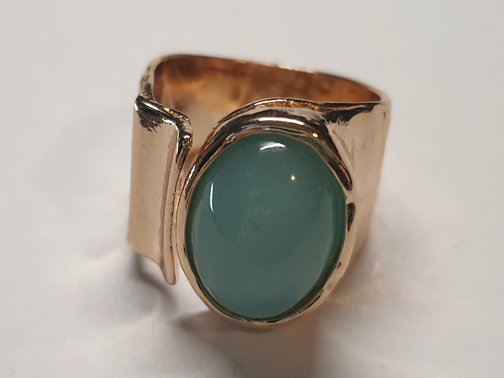 Złoty pierścionek ze stali nierdzewnej z owalnym kamieniem w kolorze morskiej zieleni, o nieregularnej formie w stylu artystycznym i retro. Rozmiar 16 mm. stal chirurgiczna, stal nierdzewna, wodoodporne, hipoalergiczne, jakość premium, RougeBizu.
