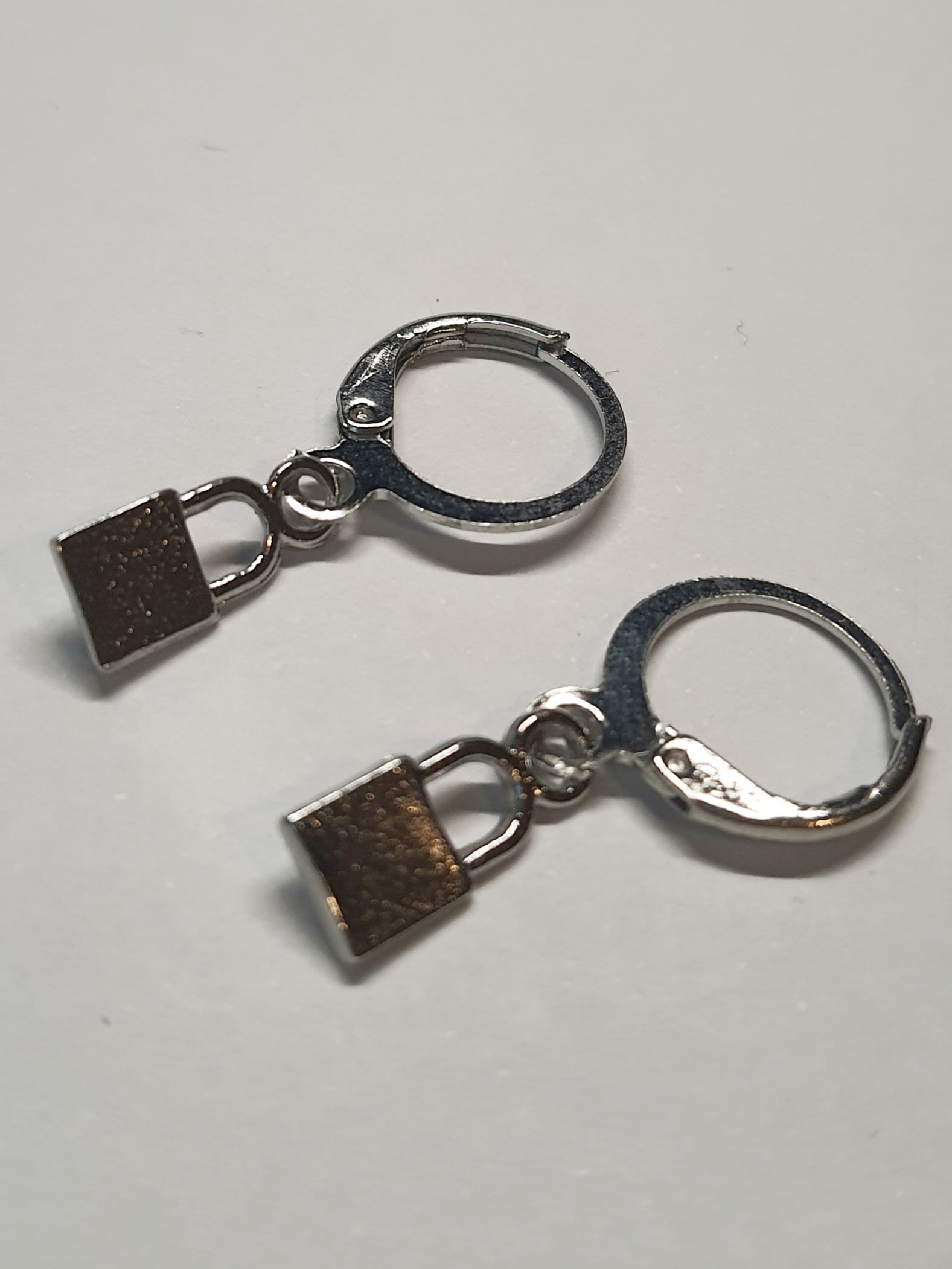 Srebrne kolczyki delikatne kółka z zawieszką w kształcie kłódeczki, długość 2,5 cm, stal chirurgiczna, stal nierdzewna, wodoodporne, hipoalergiczne, jakość premium, RougeBizu.