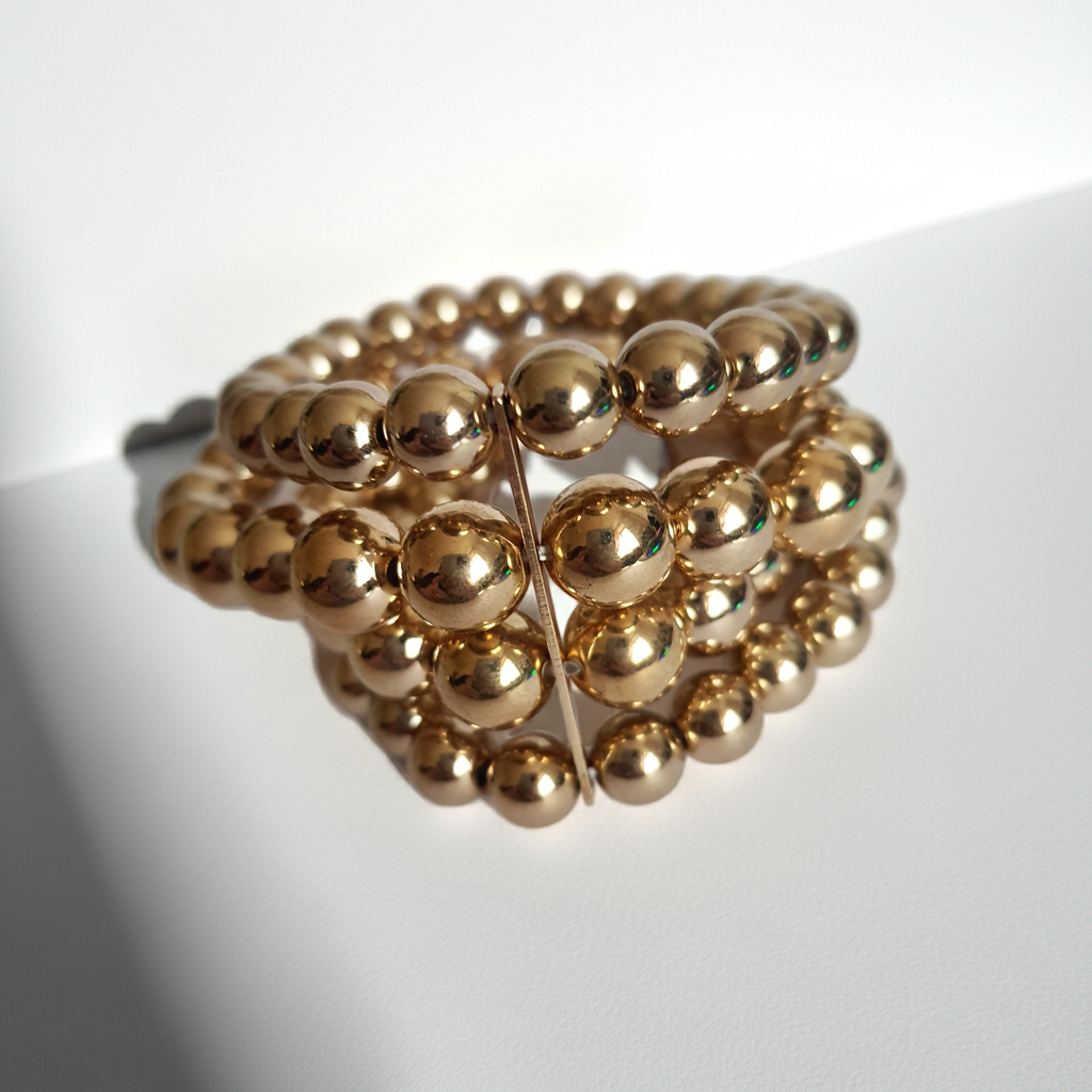 Bransoleta elastyczna na gumce z wielorzędowych złotych koralików, elegancka i klasyczna, Rouge Bizu.