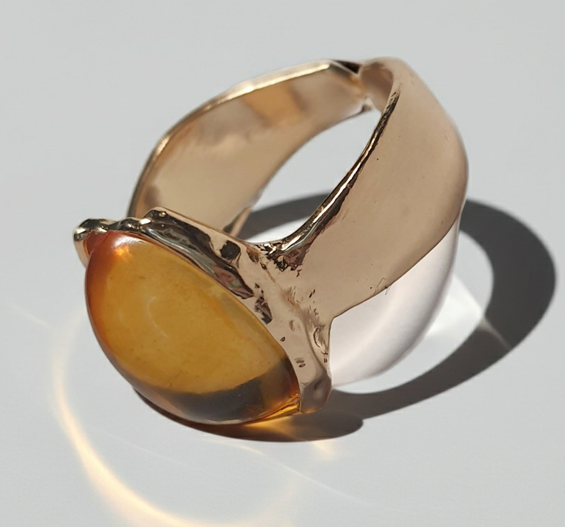 Złoty pierścionek ze stali nierdzewnej z owalnym bursztynowym kamieniem w artystycznej oprawie o nieregularnej formie. Rozmiar 16 mm. stal chirurgiczna, stal nierdzewna, wodoodporne, hipoalergiczne, jakość premium, RougeBizu.